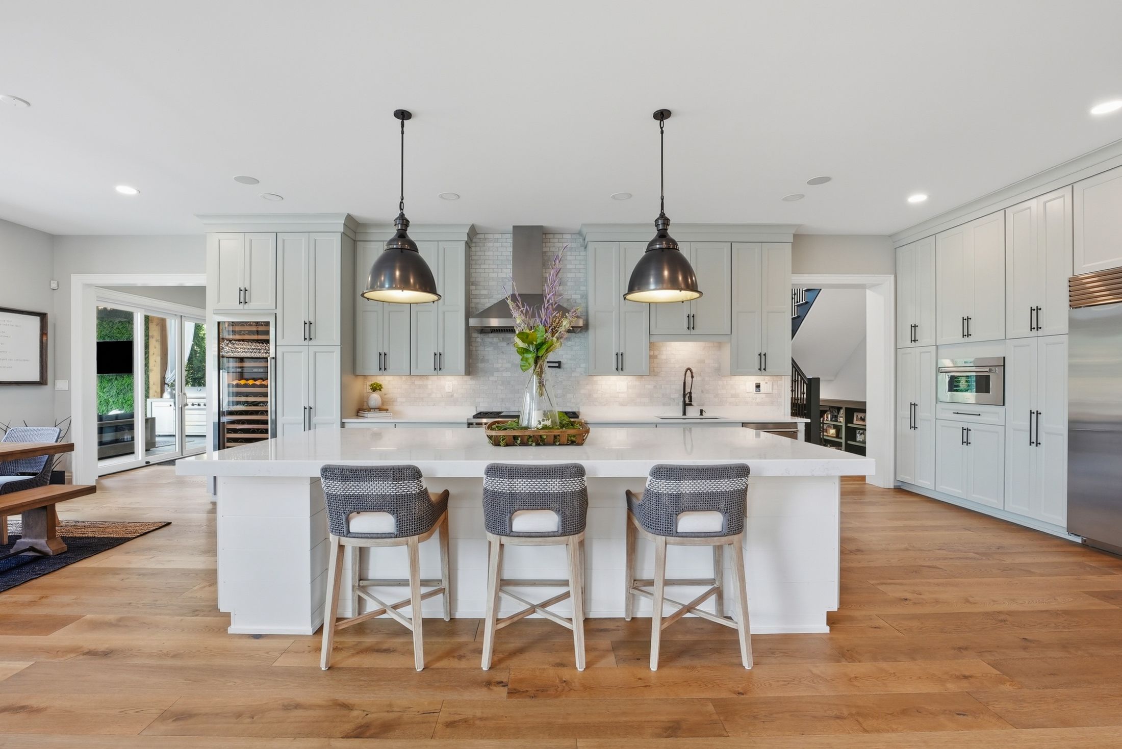 Kitchen island with pendants and glass wine column